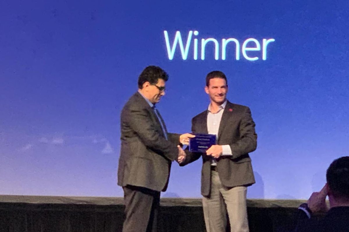 Derek Newbern receiving the award plaque on stage, Nokia, January 2019