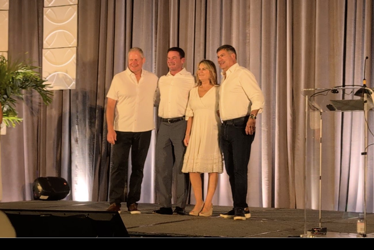 Derek Newbern on stage receiving Spirent Global Sales Leader of the Year at the 2025 Global Sales Meeting